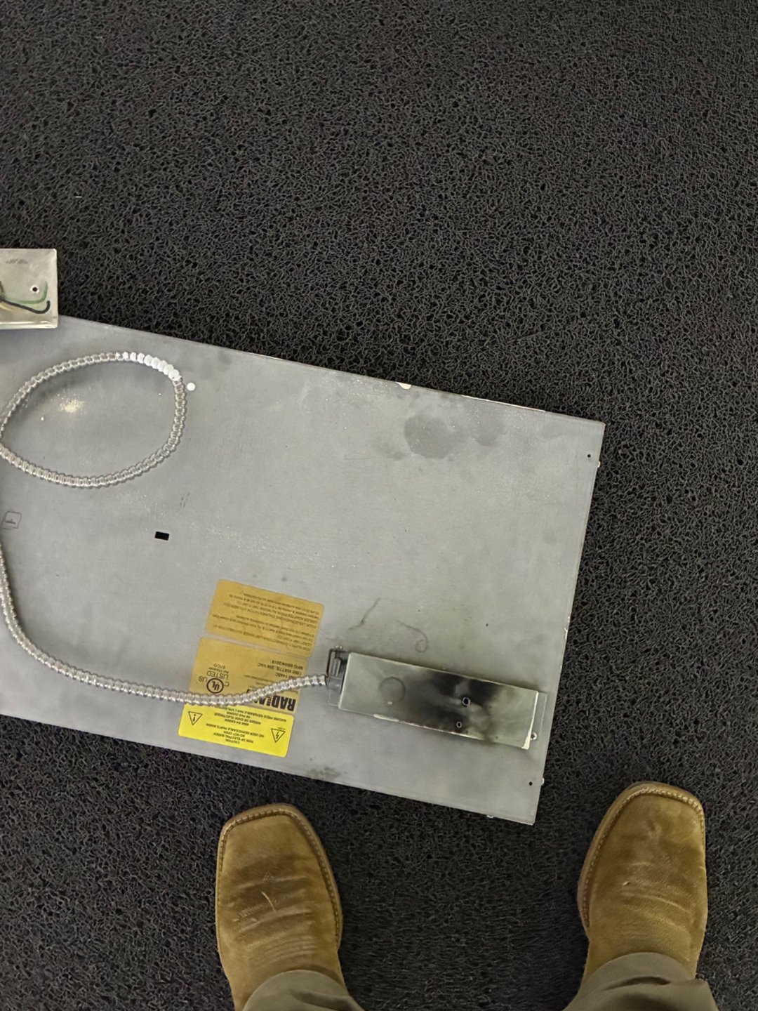 Before repair: visible heat damage on the heating-panel connection cover.
