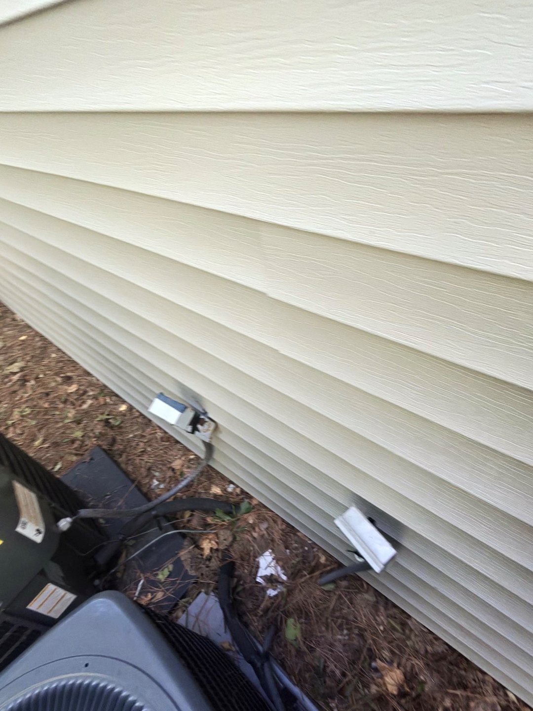 A/C disconnects and associated wiring beside the siding at the HOA project